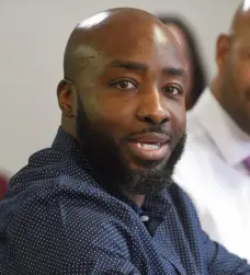 Shawnfatee Bridges speaking with community members